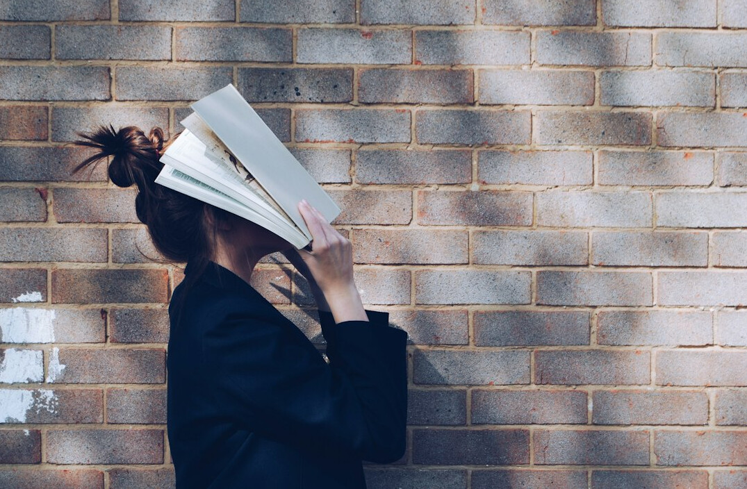person exploring personal development books